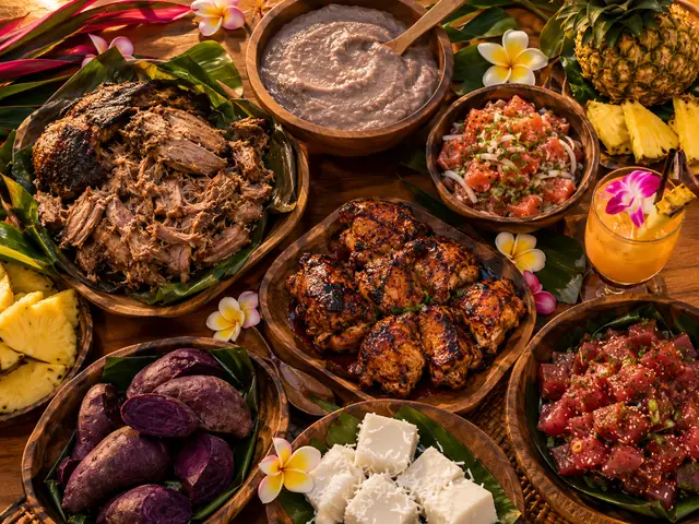 Hawaiian luau feast with kalua pork, poi, poke, pineapple and a mai tai