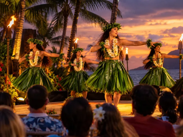 Hula dancers in ti-leaf skirts performing on a luau stage at dusk